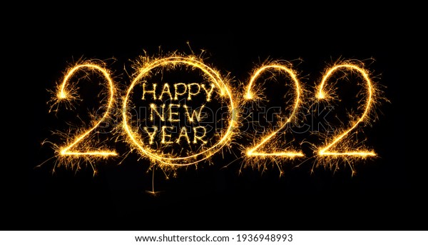 Happy New Year 2022. Creative lettering Happy New Year 2022 written burning sparklers on black background. Beautiful sparkling overlay template for design for holiday congratulation card and flyer