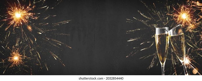 HAPPY NEW YEAR 2022 - Festive silvester background panorama banner long - Golden yellow firework and two champagne classes toasting on black night texture