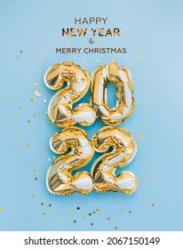 Happy New Year 2022 greeting card. 2022 golden foil balloons numbers and confetti. Top horizontal view copy space new year and christmas holiday concept. - Shutterstock ID 2067150149