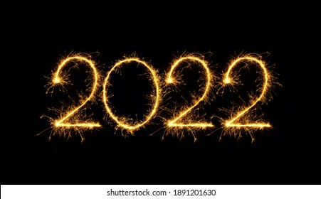 Happy New Year 2022. Sparkling burning numbers Year 2022 isolated on black background. Beautiful Glowing golden overlay object for design holiday greeting card, billboard and Web banner