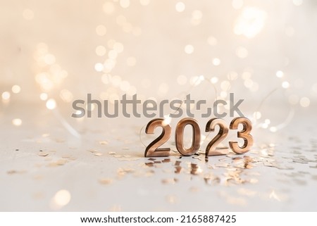 happy new year 2023 background new year holidays card with bright lights,gifts and bottle of hampagne