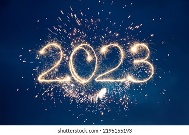 Happy New Year 2023. Beautiful creative holiday background with fireworks and Sparkling font 2023