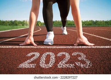 happy new year 2023. concept of starting a business or career in the new year. woman preparing for running. opening a business in 2023. transition to a new level concept. hope and expectation in 2023. - Shutterstock ID 2228297227