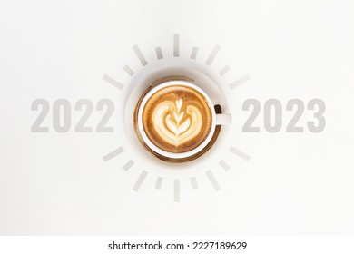 Happy new year 2023. A cup of hot latte art choose change 2022 to 2023 on white background. Start concept - Shutterstock ID 2227189629