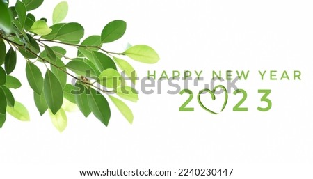 'HAPPY NEW YEAR 2023' in green color with ficus branches and leaves background, concept for greeting invitation card and happy new year 2023 concept.