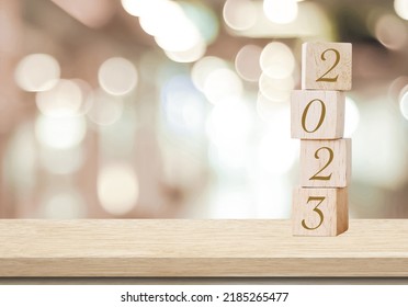 Happy New Year 2023 on wood cube block and blur abstract bokeh light background with cop space for text, Happy new year 2023 greeting card, banner - Shutterstock ID 2185265477