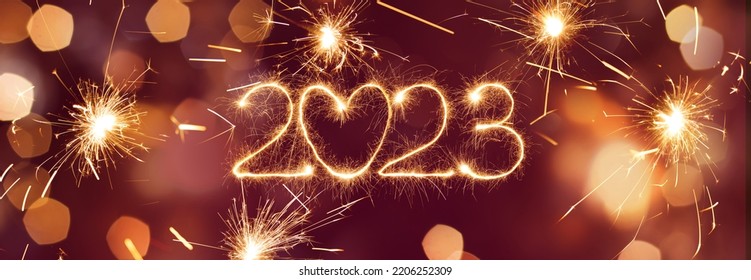 Happy New Year 2023. Panoramic New Year web banner. Beautiful holiday billboard with Sparkling creative text 2023 with heart on festive glowing red background - Shutterstock ID 2206252309