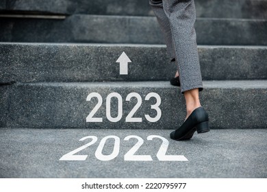 Happy new year 2023. Stepping going up stairs in city, Closeup legs of businesswoman hurry up walking on stairway from 2022 to 2023, foot of business woman wear black shoes step up success next years - Shutterstock ID 2220795977