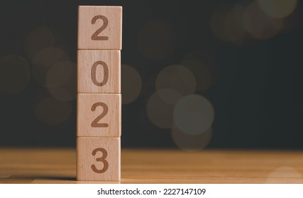 Happy new year 2023, vertical wood blocks cube or square with number 2023 on wood table, flair light background. New year 2023 concept. - Shutterstock ID 2227147109