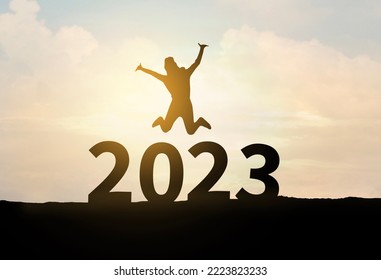 Happy new year 2023. Woman silhouette jumping on 2023 numbers. Celebration concept. - Shutterstock ID 2223823233