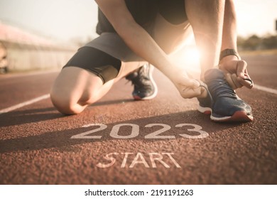 happy new year 2023,2023 symbolises the start into the new year.Start of people running on street,with sunset light.Goal of Success - Shutterstock ID 2191191263