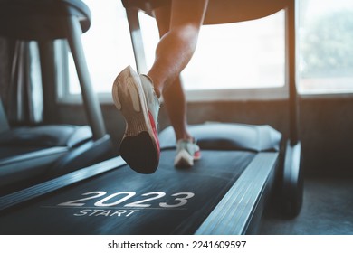 Happy new year 2023,2023 symbolizes the start of the new year. Close up of feet, sportman runner running on treadmill in fitness club. Cardio workout. Healthy lifestyle, guy training in gym. - Shutterstock ID 2241609597