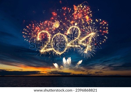 Happy New Year 2024. Beautiful creative holiday web banner or flyer with red fireworks and Golden sparkling number 2024 on blue sky over water