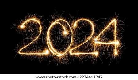 Happy New Year 2024. Burning sparkling text 2024 isolated on black background. Beautiful Glowing design element for greeting card and holiday flyer 