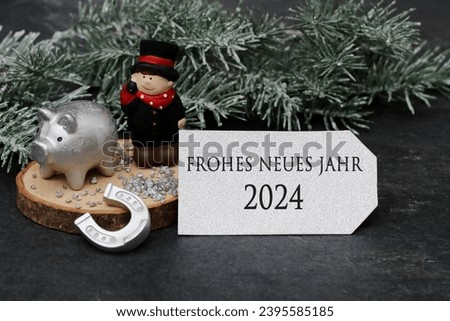 Happy New Year 2024: chimney sweep, lucky pig, horseshoe and a card with congratulations for the New Year. German inscription translated means Happy New Year 2024.