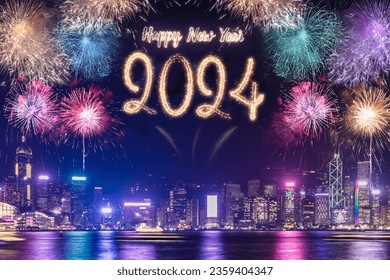Happy new year 2024 firework over cityscape building near sea at night time celebration