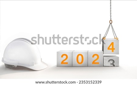 happy new year 2024. success in real estate, construction industry. crane construction lifting new concrete cube replace the old year