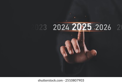 Happy New Year 2025, Hand touch on a virtual screen 2025, New Goals, Plans, and numbers for Next Year, Businessman touching future growth year 2024 to 2025, Planning, opportunity, business strategy. - Powered by Shutterstock