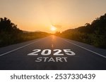 Happy new year 2025,2025 symbolizes the start of the new year. The letter start new year 2025 on the road in the nature route roadway sunset tree environment ecology greenery wallpaper concept.