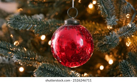 Happy New Year Christmas tree decorates with red glass ball on branch snow on background bokeh of side flickering light bulbs garlands for family winter holiday. Festival mood. Noel. Navidad - Powered by Shutterstock