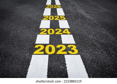 Happy new year concept and business opportunity idea. Future ahead 2023 to 2026 on asphalt road surface with marking lines