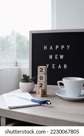 Happy New Year concept. Wooden cube with the number 2023 with letter board and notebook plan on office desk. - Shutterstock ID 2230067805