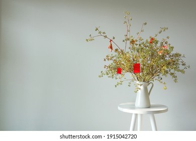 Happy New Year Decoration With Vase Flower On A White Table. Lucky Charm And Red Envelop Decoration Of Apricot Flower Branch At Home For Wishing Lucky On Lunar Chinese New Year         