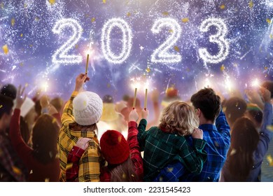 Happy new year. Family watching fireworks. Parents and kids celebrate new 2023 year. Winter holiday party. Outdoor fun. Children, mother and father with sparkler watch firework show. - Powered by Shutterstock
