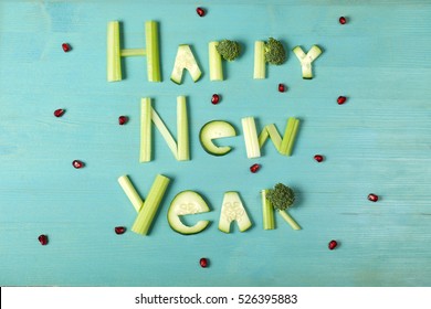 Happy New Year, Food Lettering, Vegetable Word On Bl Wooden Background With Berries 