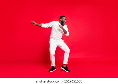 Happy New Year Guys! Full Size Photo Of Funny Dark Skin Man Dancing At Newyear Corporate Party Wear Knitted Sweater Trousers Isolated Red Background