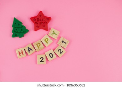 Happy New Year and Merry Christmas. Scrabble letters, playdough and plasticine. Letter tiles spelling celebration holiday.
