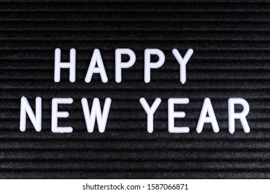 Happy New Year message displayed on a felt letter board.