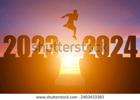 Happy New Year Numbers 2024, Silhouette a man handsome jumping feels happy moving morning 2023 to 2024 sunrise over the horizon background,Health and Happy new year concept.