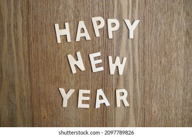 Happy new year written with wooden letters on the table