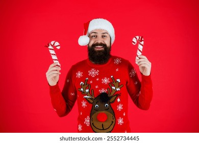 Happy New Year. Xmas holiday celebration. Santa Claus man at New Year eve. December holiday party for man in Santa hat. Xmas sweater. Christmas candy cane. Merry Christmas. Winter wonderland - Powered by Shutterstock