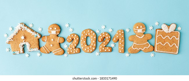 Happy New Year's set of numbers 2021, gingerbread man in face mask from ginger biscuits glazed sugar icing decoration on blue background, minimal seasonal pandemic winter holiday banner - Powered by Shutterstock