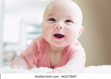 Happy Newborn Baby Girl With A Big Smile