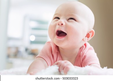 Happy Newborn Baby Girl With A Big Smile