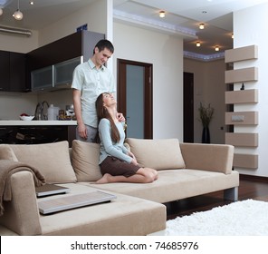 Happy Newly Married Couple At Home On Sofa