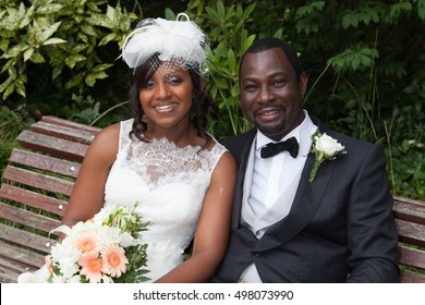 Happy newly wed african american couple on a bench