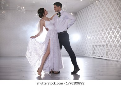 Happy newlywed couple dancing together in festive hall - Powered by Shutterstock
