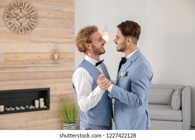 Happy Newlywed Gay Couple Dancing At Home