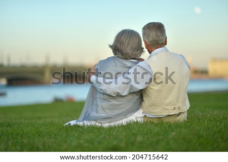 Happy nice mature couple looking at town