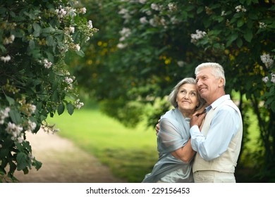 Happy Nice Mature Couple Walking In Town