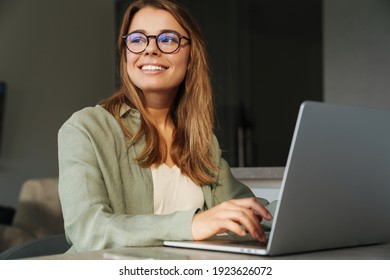 Happy Nice Woman Smiling And Working With Laptop While Sitting At Home