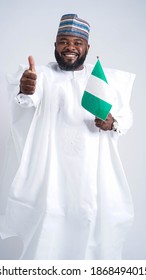 Happy Nigerian Man Dressed In Traditional Attire Giving A Thumbs Up