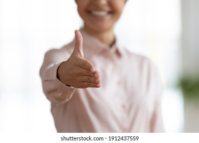 Happy office employee giving hand for shaking . Arm of business woman offering handshake. Professional welcoming colleague or new partner. HR manager hiring greeting at job interview. Close up shot - Powered by Shutterstock