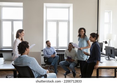 Happy Office Friends Chatting In Office, Discussing Success, Sharing Ideas, Brainstorming On Project, Laughing, Smiling. Diverse Team Meeting At Workplaces, Sitting, Standing In Circle