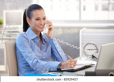 Happy Office Worker Girl On Landline Phone Call, Smiling, Listening To Conversation.?