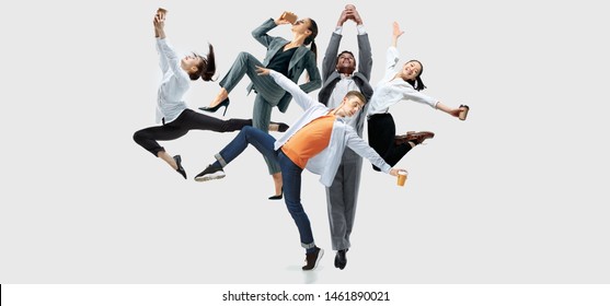Happy office workers jumping and dancing in casual clothes or suit with folders on white. Ballet dancers. Business, start-up, working open-space, motion and action concept. Creative collage.